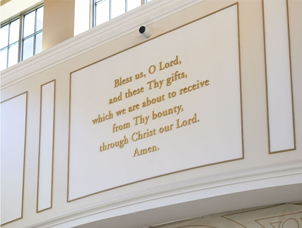 Grace prayer plaque in South Dining Hall reading, 'Bless us, O Lord, and these Thy gifts, which we are about to receive from Thy bounty, through Jesus Christ our Lord. Amen.
